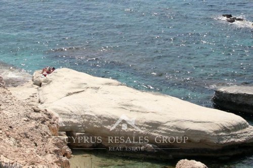 Reading morning paper on the rocks in Sea Caves, Cyprus
